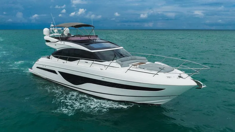 Slide: The Image of 2022 Princess S66 yacht cruising on turquoise ocean waters under a cloudy sky. - 19