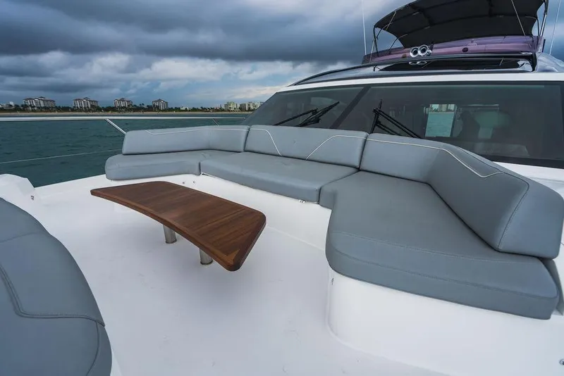 Slide: The Image of Luxurious 2022 Princess S66 yacht with spacious outdoor seating and elegant wooden table. - 48
