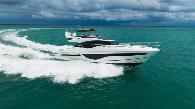 Slide: The Image of Luxurious 2022 Princess S66 yacht cruising on turquoise ocean under cloudy skies. - 5