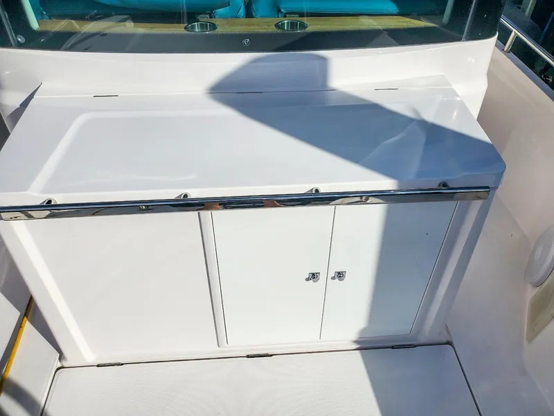 Slide: The Image of 2021 Axopar 28 CABIN boat interior with white storage cabinet. - 15