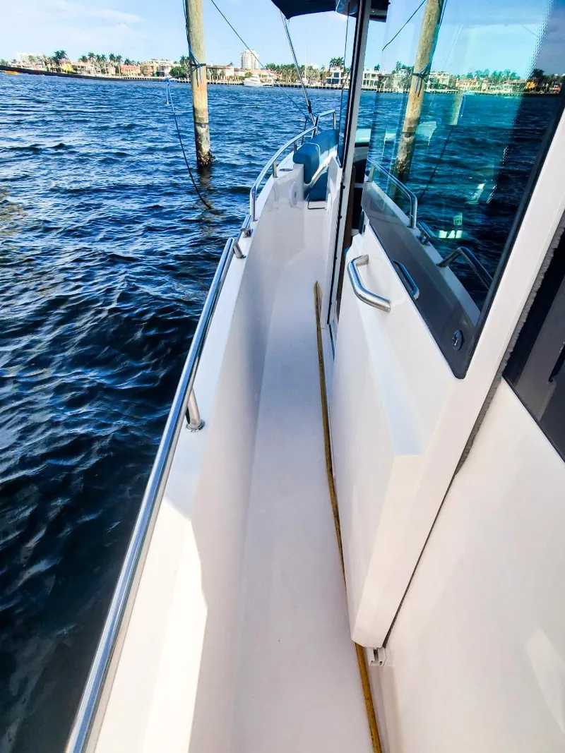 Slide: The Image of 2021 Axopar 28 CABIN boat on water, side view with clear skies. - 21