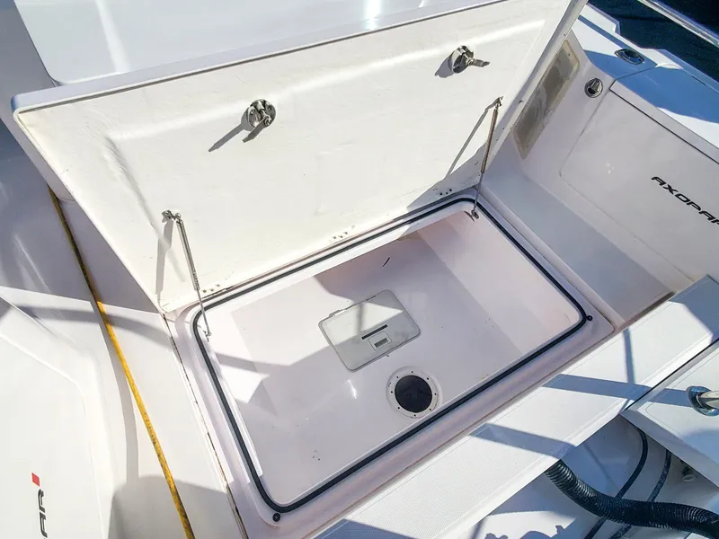 Slide: The Image of Axopar 28 CABIN 2021 storage compartment open, showcasing interior space and design. - 24