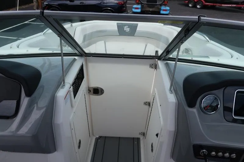 Slide: The Image of 2020 Chaparral 21 Surf boat interior with dashboard and seating area. - 17