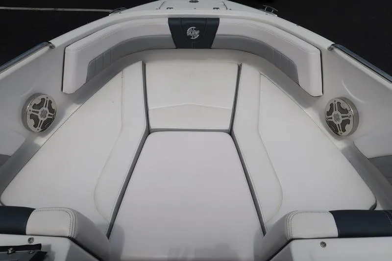 Slide: The Image of 2020 Chaparral 21 Surf boat interior with white cushioned seating and speakers. - 27