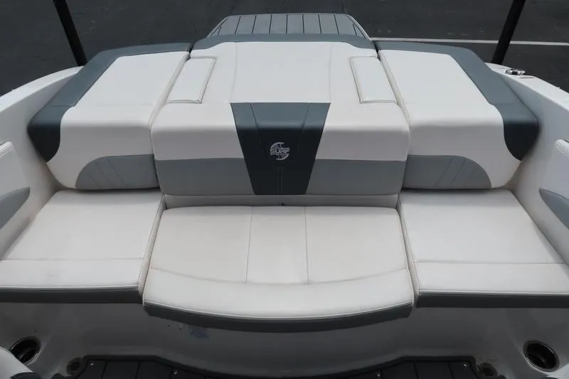 Slide: The Image of 2020 Chaparral 21 Surf boat, featuring a sleek, cushioned seating area in white and gray. - 6