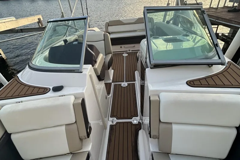 Slide: The Image of 2015 Regal 27 FasDeck boat interior with dual windshields and cushioned seating. - 12