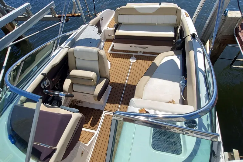 Slide: The Image of 2015 Regal 27 FasDeck boat interior with beige seating and wood flooring. - 19