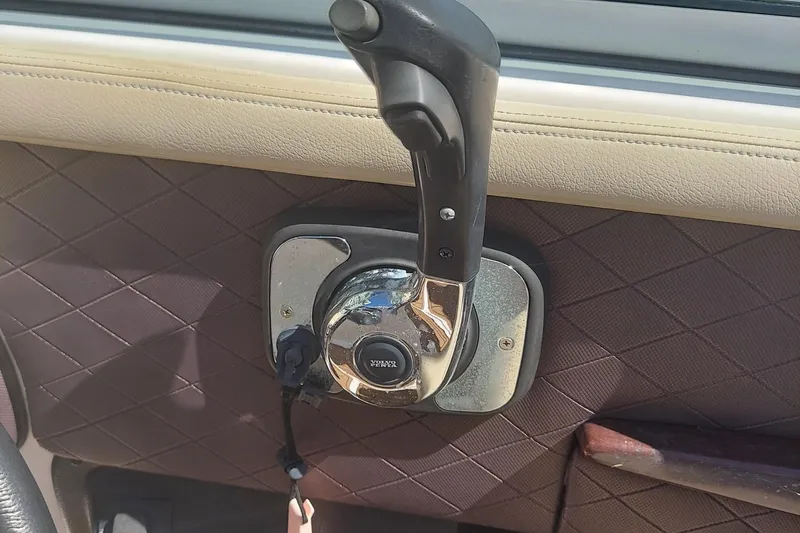 Slide: The Image of Throttle control lever on a 2015 Regal 27 FasDeck boat, featuring Volvo Penta branding. - 22