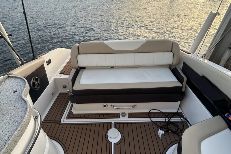 Slide: The Image of 2015 Regal 27 FasDeck boat interior with cushioned seating and teak flooring. - 3
