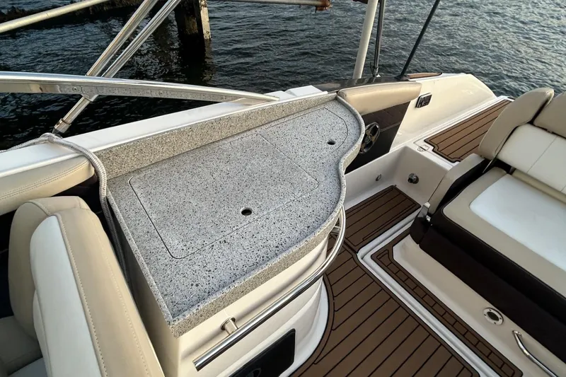 Slide: The Image of 2015 Regal 27 FasDeck boat interior with granite countertop and cushioned seating. - 5