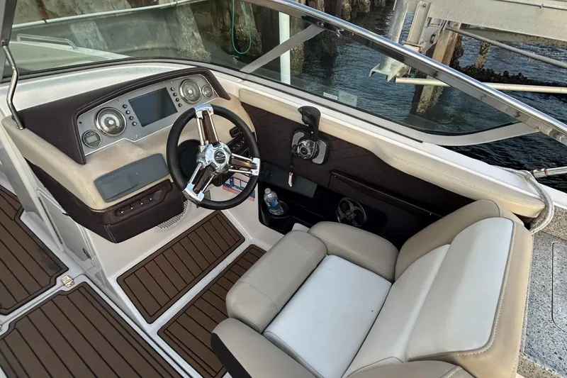 Slide: The Image of 2015 Regal 27 FasDeck boat cockpit with steering wheel and control panel. - 8