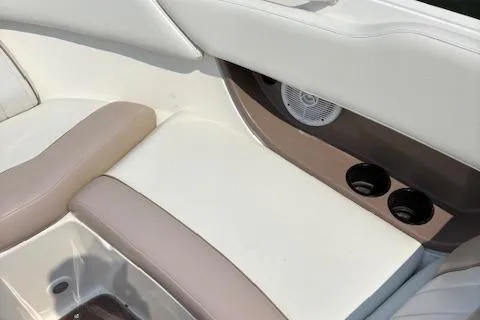 Slide: The Image of 2003 Regal 2200 Bowrider interior with beige seating and cup holders. - 10