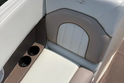 Slide: The Image of 2003 Regal 2200 Bowrider interior with beige and white seating, featuring dual cup holders. - 11