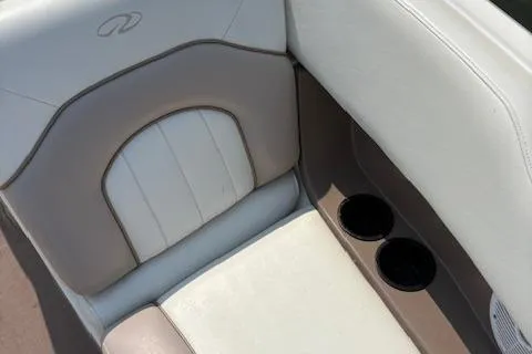 Slide: The Image of 2003 Regal 2200 Bowrider boat seat with cup holders, beige and white upholstery. - 12