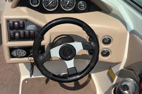 Slide: The Image of 2003 Regal 2200 Bowrider dashboard with steering wheel and control panel. - 5