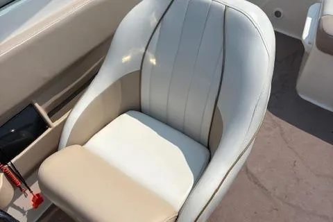 Slide: The Image of 2003 Regal 2200 Bowrider boat seat with beige and white upholstery. - 6