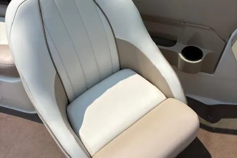 Slide: The Image of 2003 Regal 2200 Bowrider boat seat with cup holder, beige and white upholstery. - 7