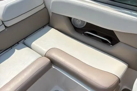 Slide: The Image of 2003 Regal 2200 Bowrider boat interior with beige and brown seating, featuring a speaker. - 9