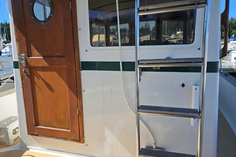 Slide: The Image of 1973 Willard Marine Vega Nomad Flybridge with wooden door and metal ladder. - 14