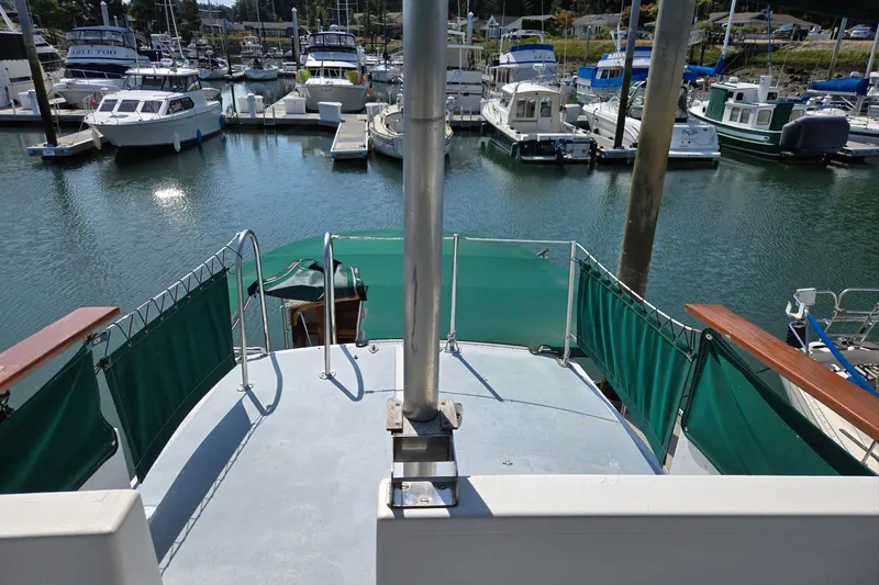 Slide: The Image of 1973 Willard Marine Vega Nomad Flybridge at marina, surrounded by boats. - 19