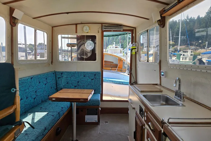 Slide: The Image of Interior of 1973 Willard Marine Vega Nomad Flybridge with seating, table, and kitchenette. - 21