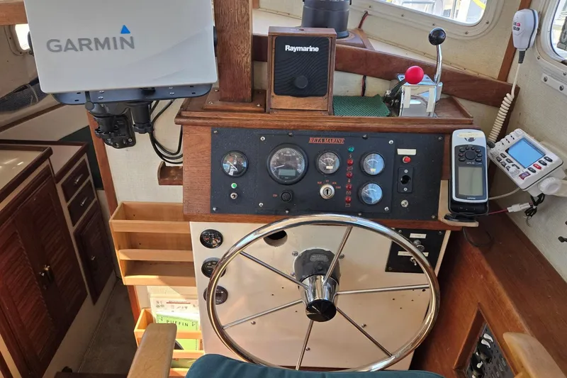 Slide: The Image of 1973 Willard Marine Vega Nomad Flybridge helm with Garmin and Raymarine navigation equipment. - 23