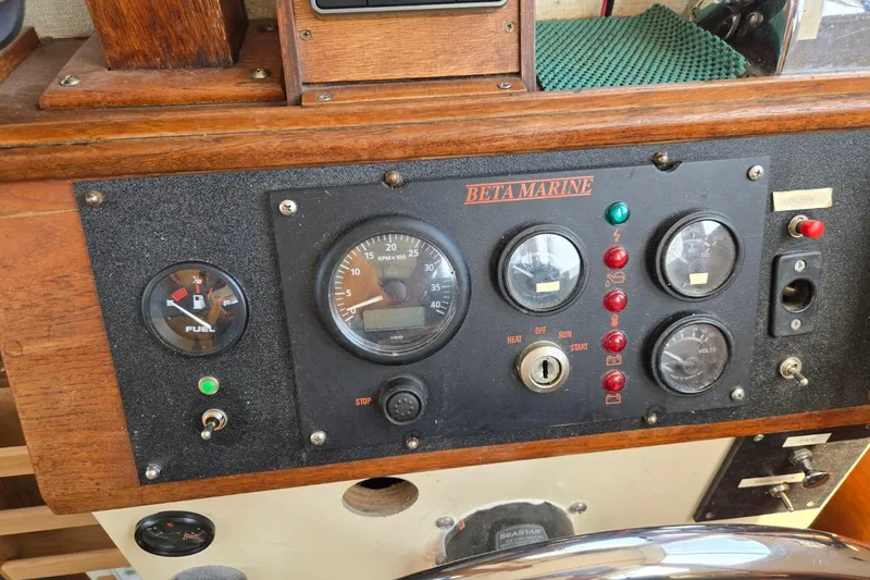 Slide: The Image of 1973 Willard Marine Vega Nomad Flybridge dashboard with Beta Marine gauges and controls. - 24