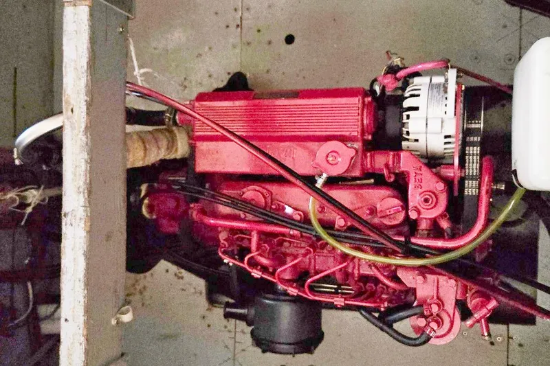 Slide: The Image of Engine of 1973 Willard Marine Vega Nomad Flybridge, featuring red components and visible wiring. - 29