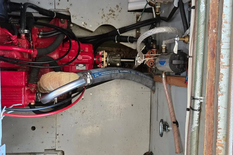 Slide: The Image of Engine compartment of a 1973 Willard Marine Vega Nomad Flybridge boat, showing mechanical components. - 30