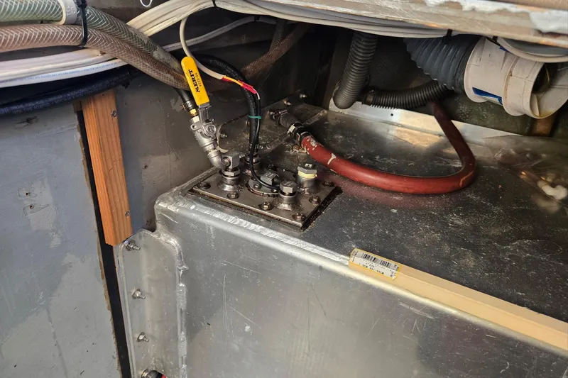 Slide: The Image of 1973 Willard Marine Vega Nomad Flybridge engine compartment with fuel lines and connections. - 35