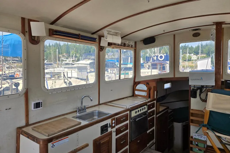 Slide: The Image of Interior of 1973 Willard Marine Vega Nomad Flybridge with kitchen and marina view. - 38