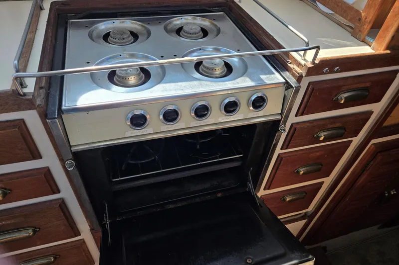 Slide: The Image of Vintage stove and oven in a 1973 Willard Marine Vega Nomad Flybridge boat kitchen. - 41