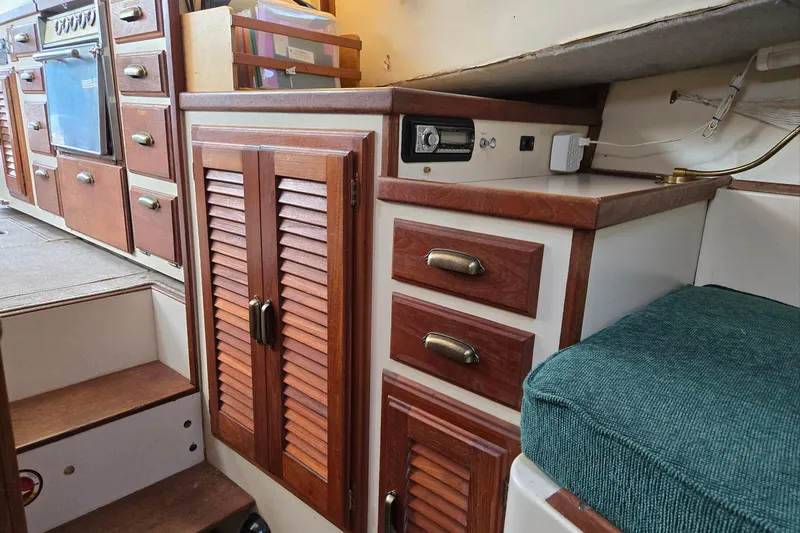 Slide: The Image of Interior of 1973 Willard Marine Vega Nomad Flybridge with wooden cabinets and seating. - 47