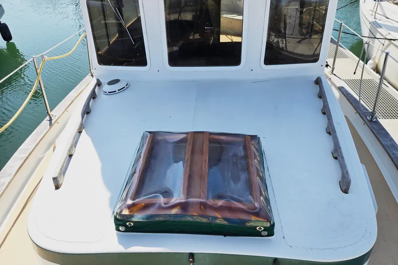 Slide: The Image of 1973 Willard Marine Vega Nomad Flybridge deck with hatch, docked at marina. - 5