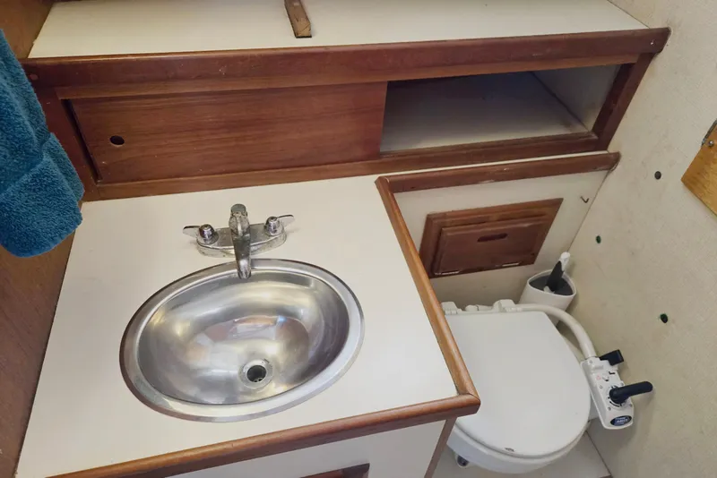 Slide: The Image of 1973 Willard Marine Vega Nomad Flybridge bathroom with sink and toilet. - 50