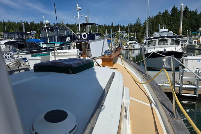 Slide: The Image of 1973 Willard Marine Vega Nomad Flybridge docked among other boats in a marina. - 6