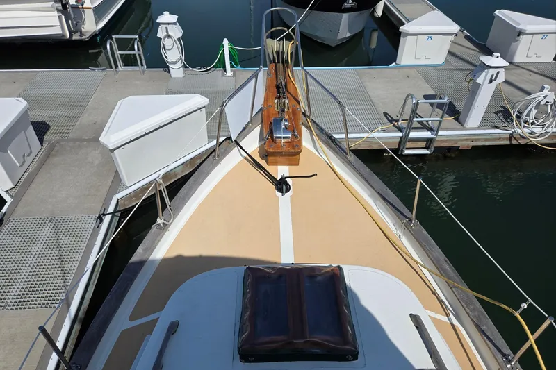 Slide: The Image of 1973 Willard Marine Vega Nomad Flybridge docked at marina, view from bow. - 7