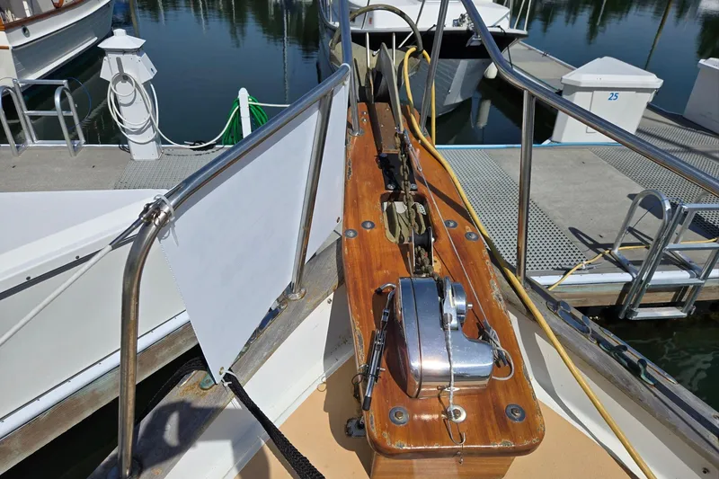 Slide: The Image of 1973 Willard Marine Vega Nomad Flybridge boat deck with winch and railing at marina. - 8