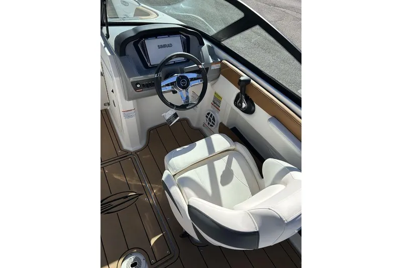 Slide: The Image of 2026 Chaparral 21 SSi boat interior with steering wheel and control panel. - 10