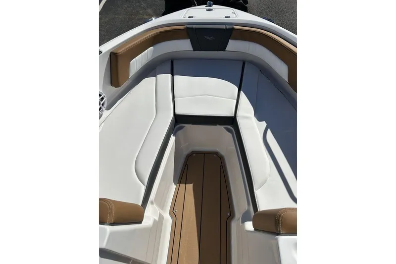 Slide: The Image of 2026 Chaparral 21 SSi boat interior with white and brown seating. - 13