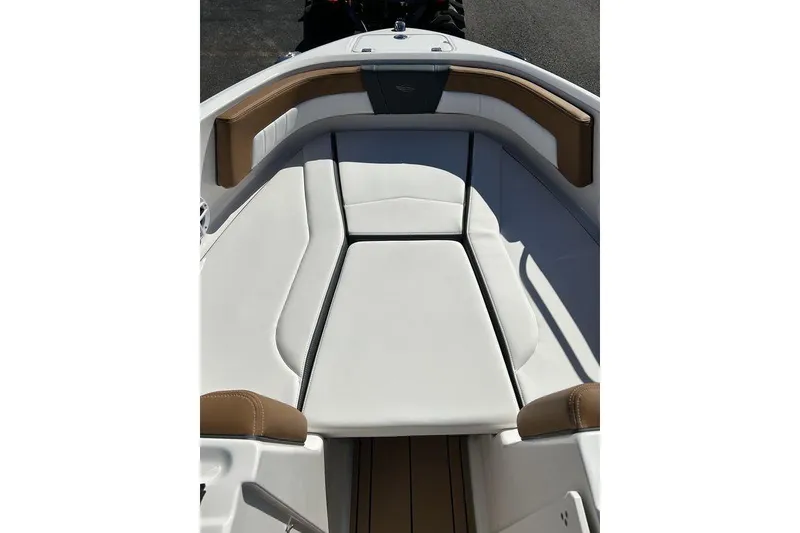 Slide: The Image of 2026 Chaparral 21 SSi boat interior with white and brown seating. - 17