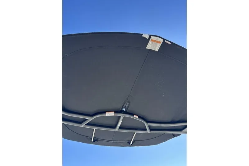 Slide: The Image of 2026 Chaparral 21 SSi boat canopy against clear blue sky. - 18