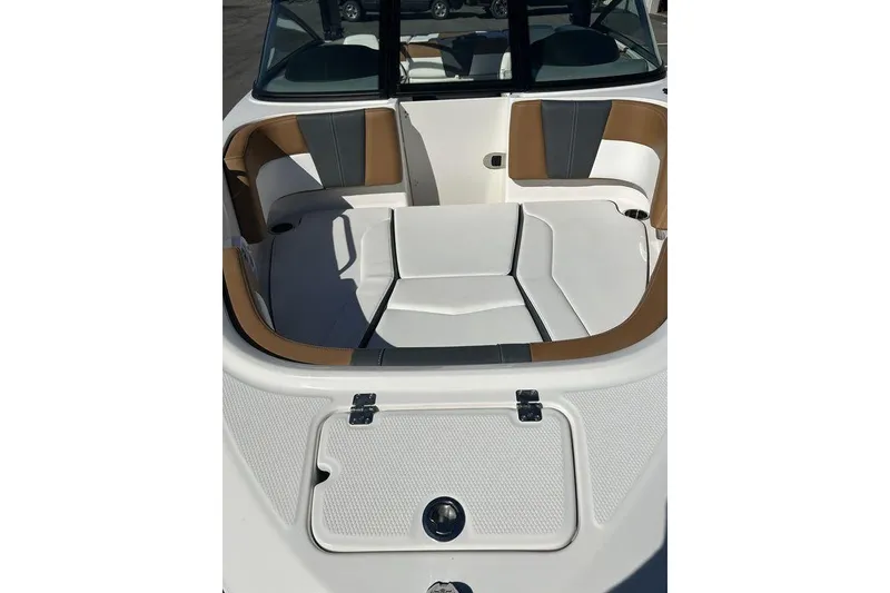 Slide: The Image of 2026 Chaparral 21 SSi boat interior with white and tan seating, open bow design. - 3