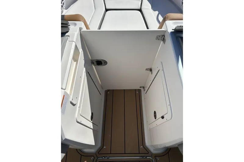 Slide: The Image of 2026 Chaparral 21 SSi boat interior with open storage compartment and teak flooring. - 7