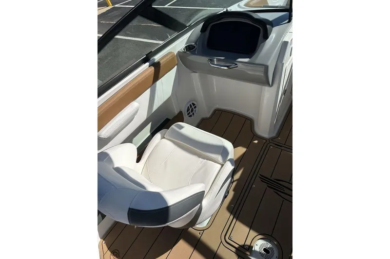 Slide: The Image of Interior of 2026 Chaparral 21 SSi boat with white seating and brown flooring. - 9