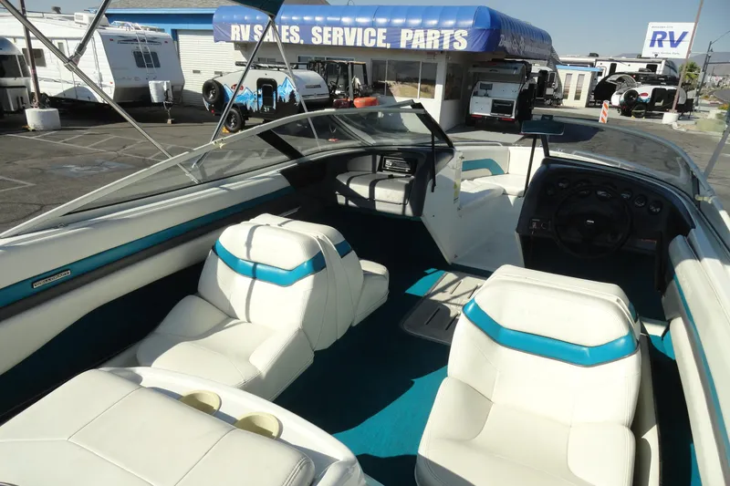 Slide: The Image of 1995 Wellcraft Eclipse 196 S boat interior with white and blue seating at RV sales lot. - 10