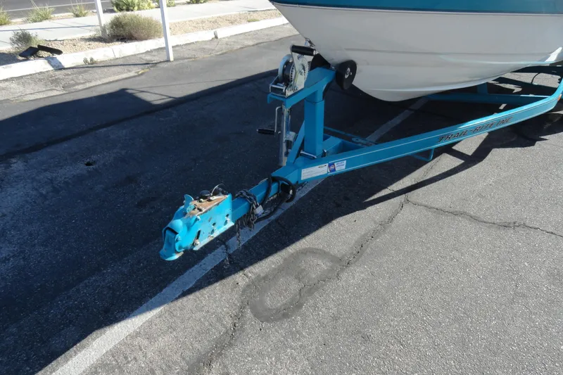 Slide: The Image of 1995 Wellcraft Eclipse 196 S boat on a blue trailer in a parking lot. - 15