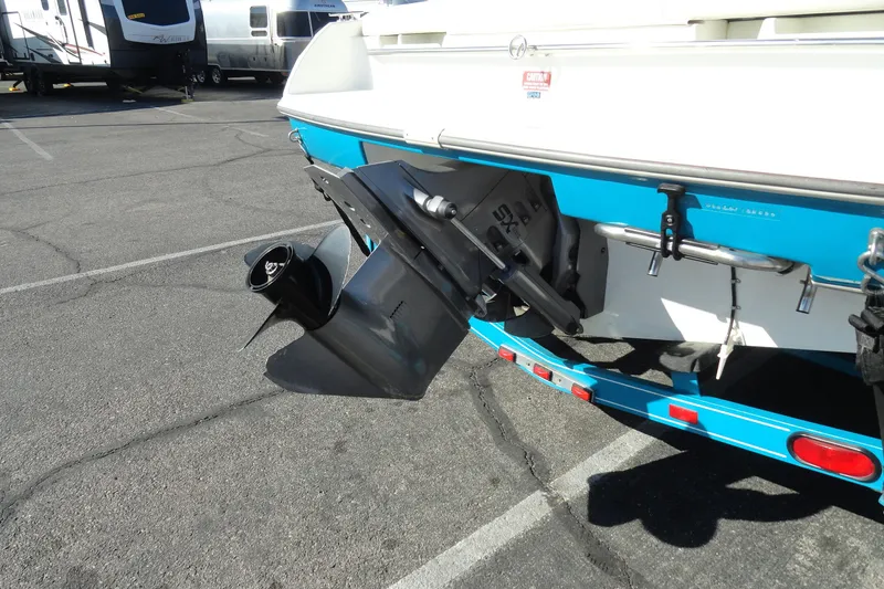Slide: The Image of 1995 Wellcraft Eclipse 196 S boat stern with propeller and trailer in parking lot. - 17