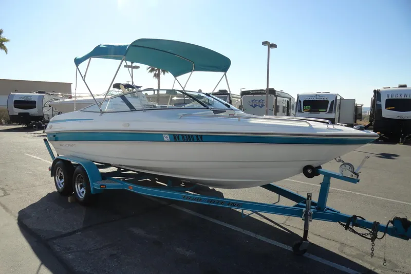 Slide: The Image of 1995 Wellcraft Eclipse 196 S boat on trailer, parked in a lot with RVs. - 4