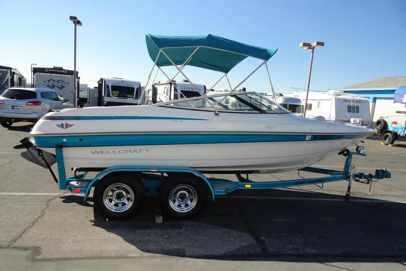 Slide: The Image of 1995 Wellcraft Eclipse 196 S boat on trailer, parked in a lot with RVs. - 5